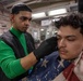 A Nimitz Sailor Cuts Hair in the Barbershop