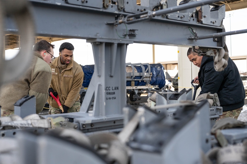 Breaking the Ice: Airmen remove snow, resume flying ops