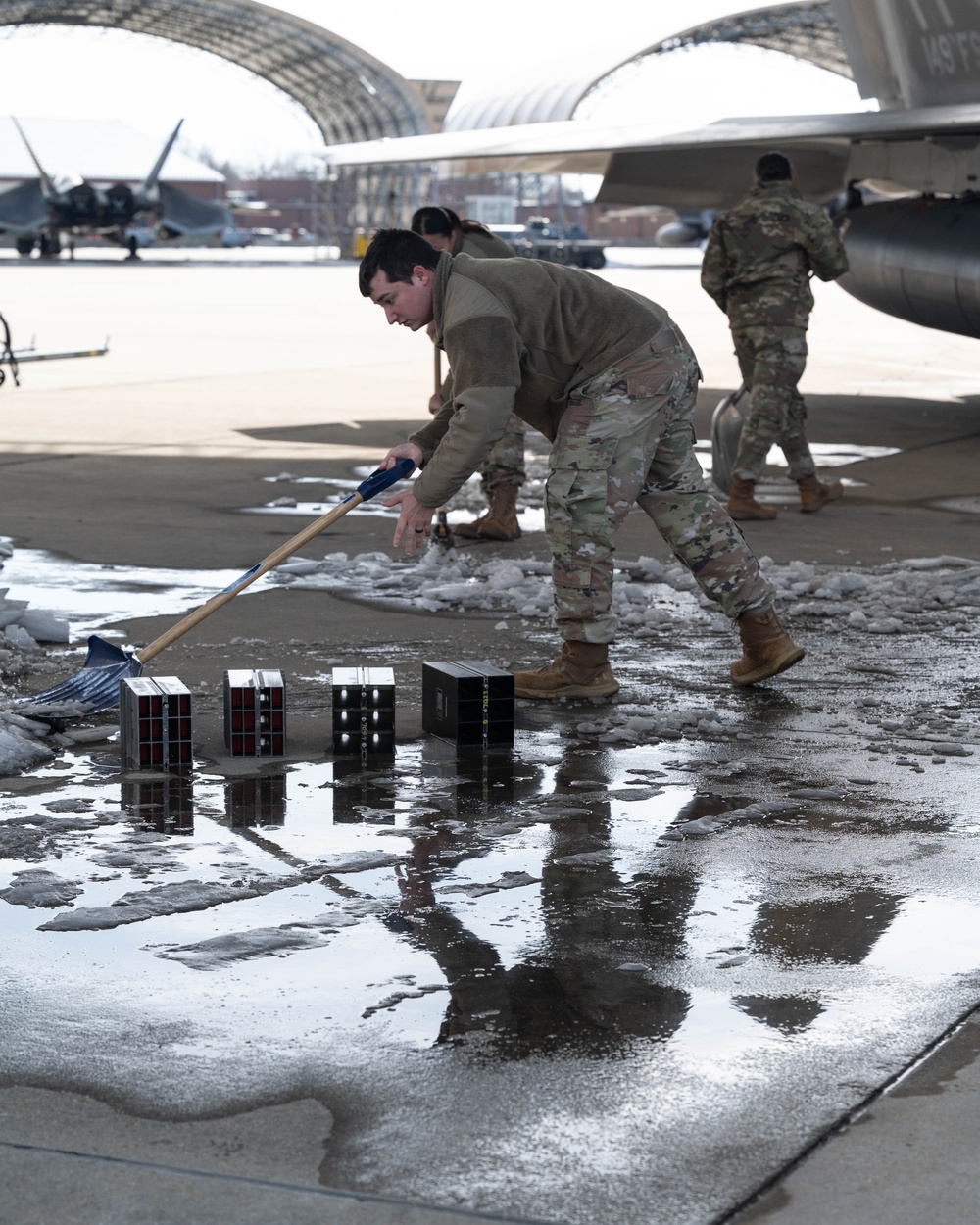 Breaking the Ice: Airmen remove snow, resume flying ops