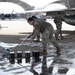 Breaking the Ice: Airmen remove snow, resume flying ops