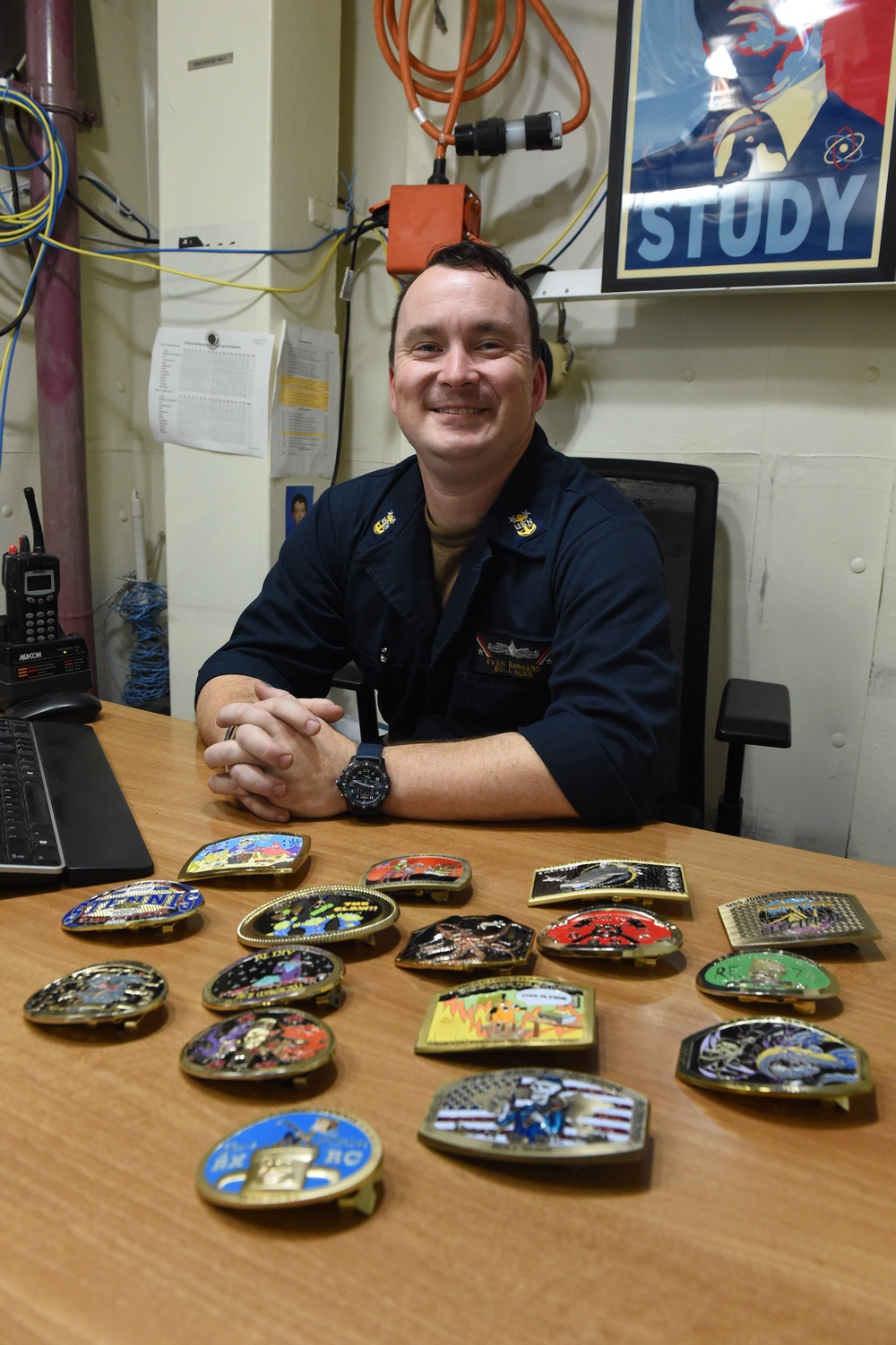 USS John C. Stennis (CVN 74) Master Chief poses with belt buckles