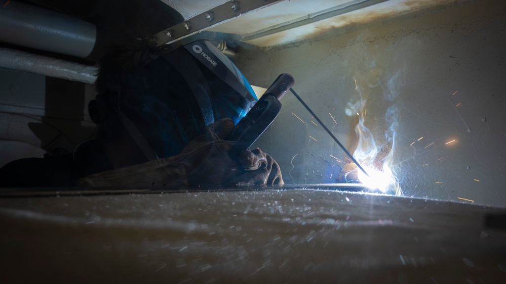 Nimitz Sailor Welds Bracing For Vending Machine