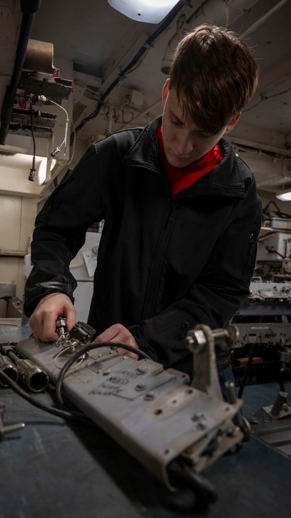 Nimitz Sailor Disassembles Bomb Rack Component