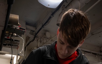 Nimitz Sailor Disassembles Bomb Rack Component