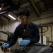 Nimitz Sailor Applies Paint Stripper To Engine Trailer Welds