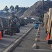 Soldier Walks along tents of other Soldiers camping at the Pacific Palisades