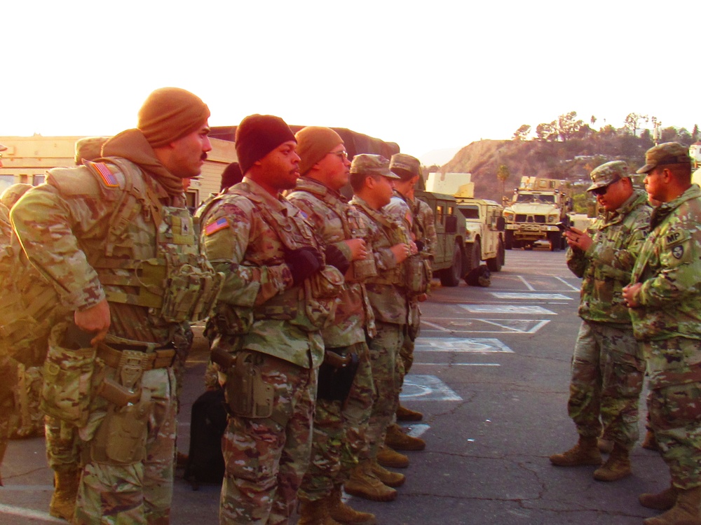 U.S. Army National Guard Soldiers await instructions for their evening shift.