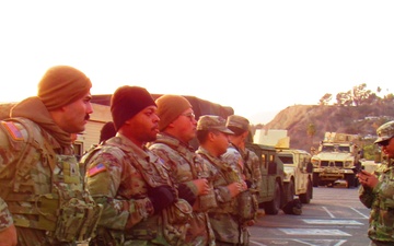 U.S. Army National Guard Soldiers await instructions for their evening shift.