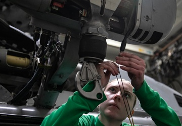 Battle Cats Conduct Maintenance on Helicopter