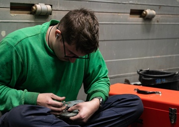 Battle Cats Perform Maintenance on Helicopter