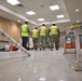 Construction Staff with OICC MCM Check Floor Quality in a Building Nearing Completion