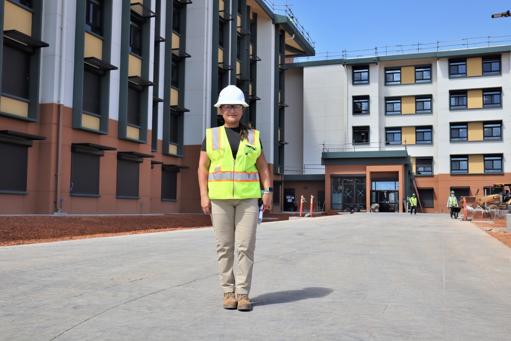 The Construction Manager for Bachelor Officer Quarters Poses with the Project