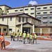 OICC Staff Walk Through Bachelor Enlisted Quarters Under Construction on Marine Corps Base Camp Blaz