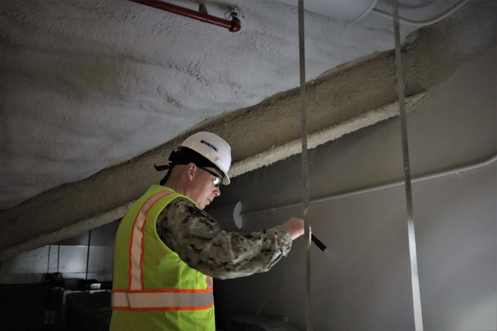 Capt. Blake Burket Checks Ductwork in a Building Nearing Completion on Marine Corps Base Camp Blaz