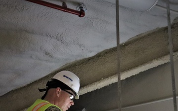 Capt. Blake Burket Checks Ductwork in a Building Nearing Completion on Marine Corps Base Camp Blaz