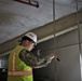 Capt. Blake Burket Checks Ductwork in a Building Nearing Completion on Marine Corps Base Camp Blaz