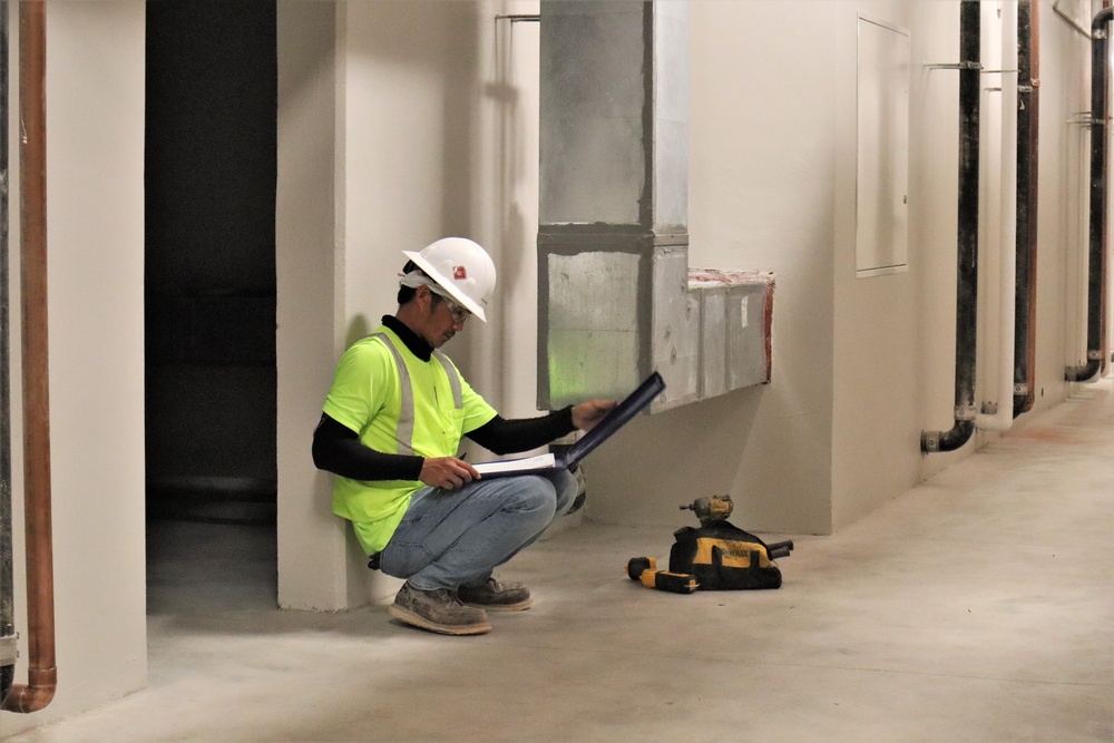 A Contractor Checks Paperwork During HVAC Installation on Marine Corps Base Camp Blaz