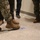 Military and Civilian Staff with the Office in Charge of Construction Point out a Defect in Floor Installation