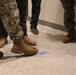 Military and Civilian Staff with the Office in Charge of Construction Point out a Defect in Floor Installation