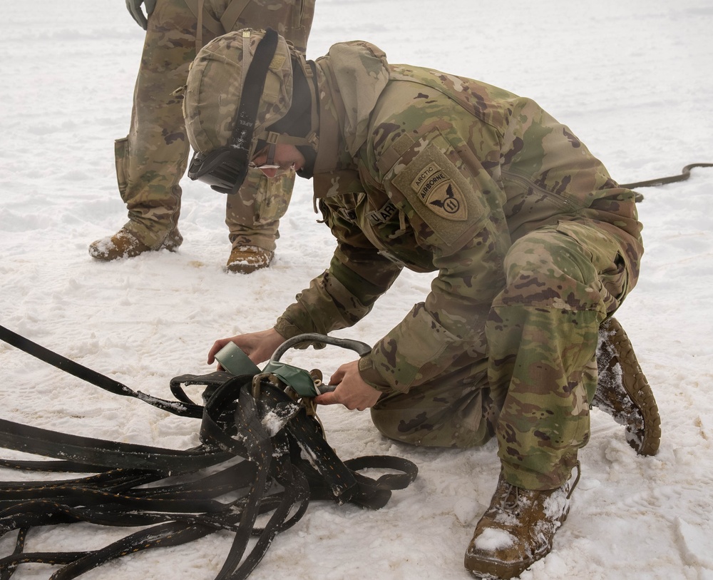 U.S.Army Sgt. Tapes a Net Apex Fitting