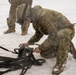 U.S.Army Sgt. Tapes a Net Apex Fitting