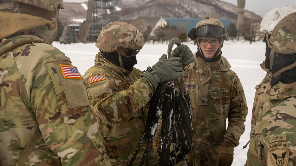 U.S. Army Pfc. Inspects a Cargo Net