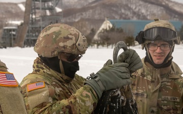 U.S. Army Pfc. Inspects a Cargo Net