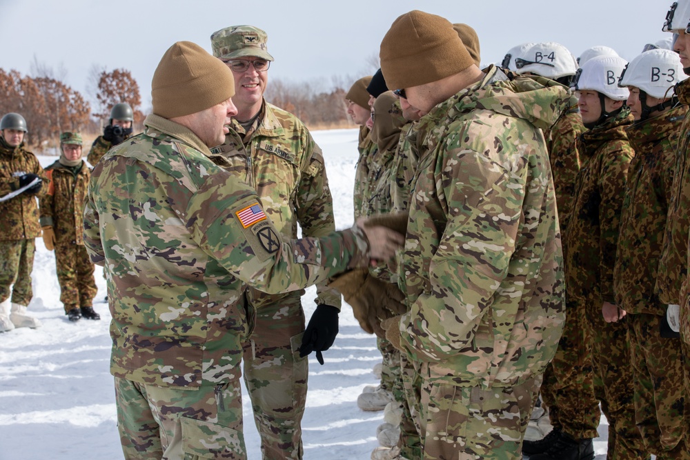Lt. Col. Ryan Hanrahan and Col. Matthew Hall Present Pvt. Antonio Jimenez With a Challenge Coin