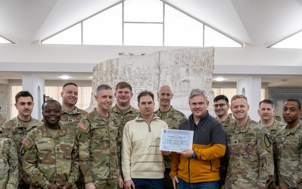 Soldiers present certificate of appreciation to the Romanian National History Museum