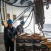 Nimitz Sailor Secures Cargo During Resupply At Sea