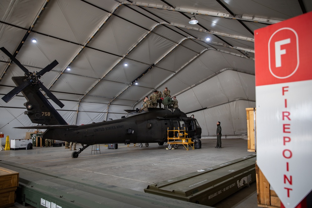 Multinational forces conduct repairs on UH60M Black Hawk