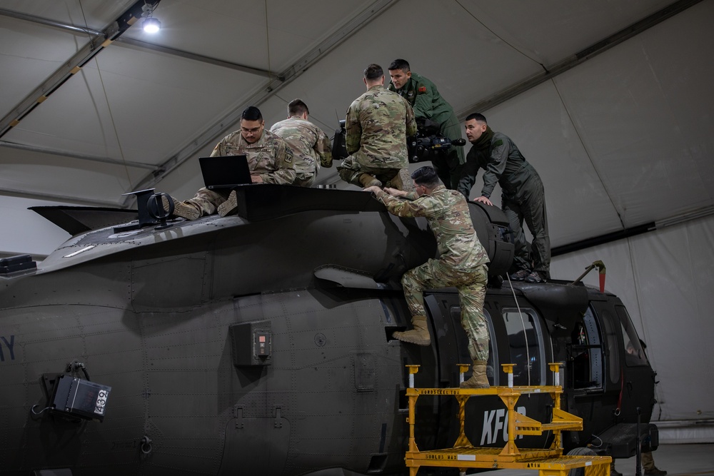 Multinational forces conduct repairs on UH60M Black Hawk