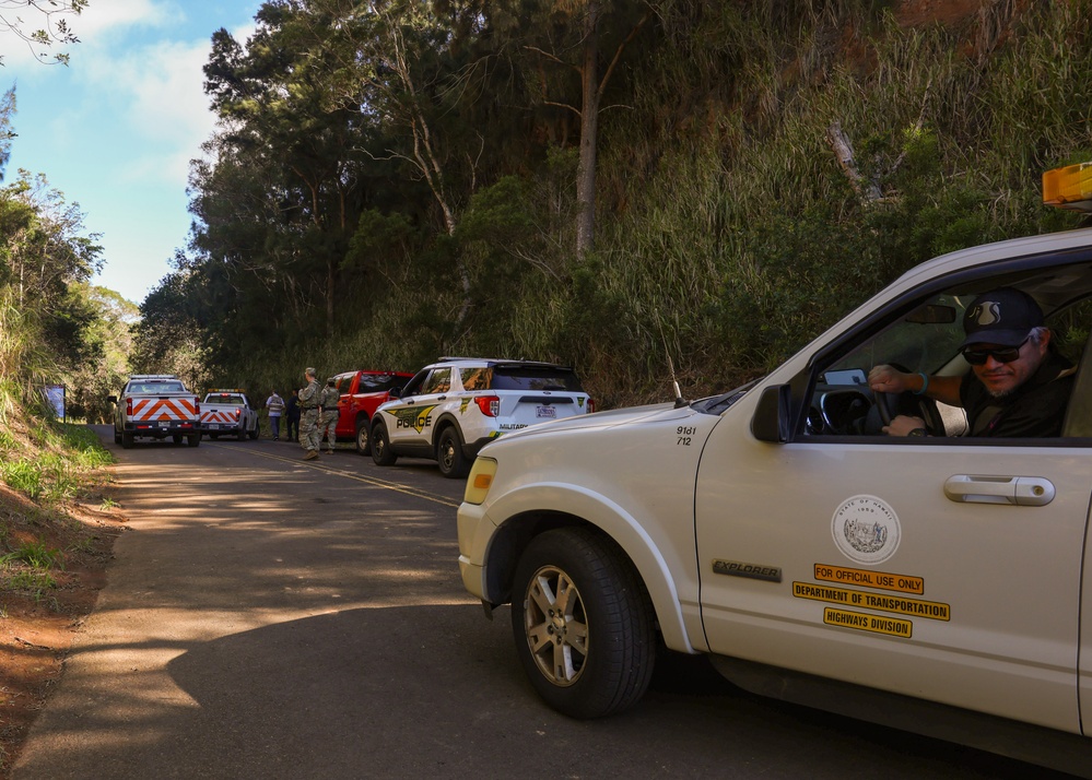 Personnel respond to a simulated car crash on the Kolekole Pass during an exercise at Lualualei Naval Complex Feb. 5, 2025.