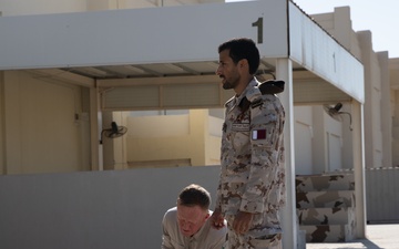 Qatar National Service Academy weapons instructor demonstrates proper weapons assembly