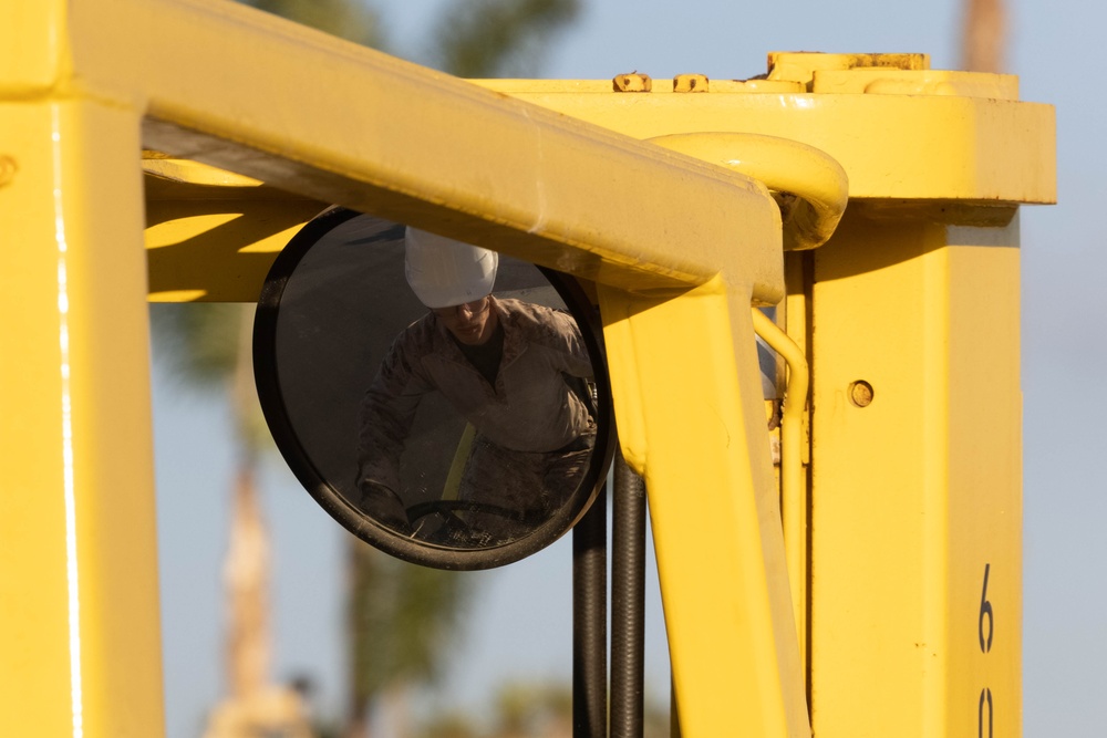 A U.S. Marine operates a forklift to relocate concertina wire in assistance with border security mission