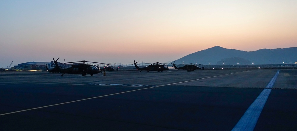 Black Hawk and Pave Hawk Helicopters on Airstrip