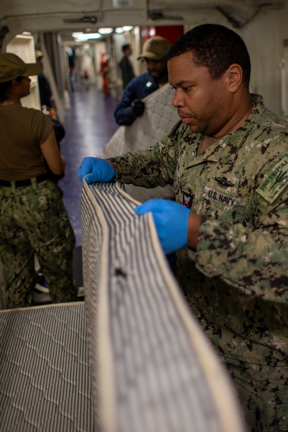 USS Tripoli Sailors Conduct Inspections and Move Mattresses