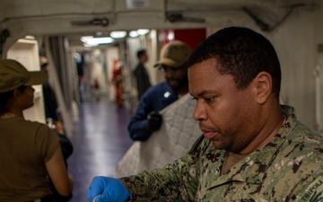 USS Tripoli Sailors Conduct Inspections and Move Mattresses