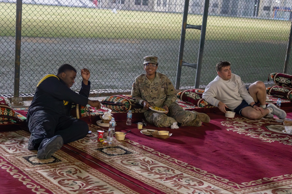 West Virginia, District of Columbia National Guard Members, and Qatar National Service Academy cadets enjoy traditional Qatari food prepared and served by staff at the National Service Academy