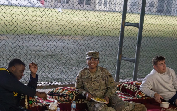 West Virginia, District of Columbia National Guard Members, and Qatar National Service Academy cadets enjoy traditional Qatari food prepared and served by staff at the National Service Academy