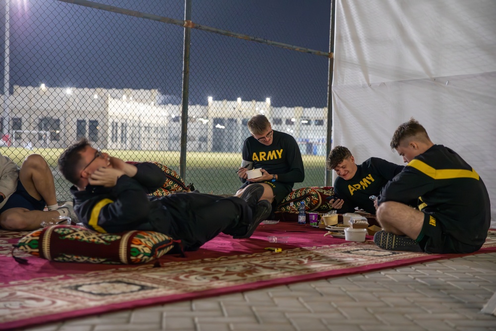 West Virginia, District of Columbia National Guard Members, and Qatar National Service Academy cadets enjoy traditional Qatari food prepared and served by staff at the National Service Academy