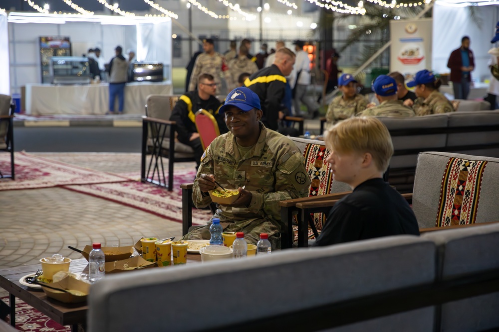 West Virginia, District of Columbia National Guard Members, and Qatar National Service Academy cadets enjoy traditional Qatari food prepared and served by staff at the National Service Academy