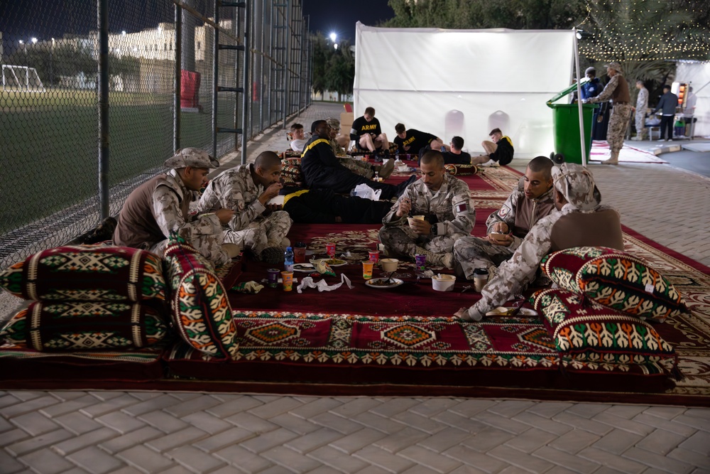 West Virginia, District of Columbia National Guard Members, and Qatar National Service Academy cadets enjoy traditional Qatari food prepared and served by staff at the National Service Academy