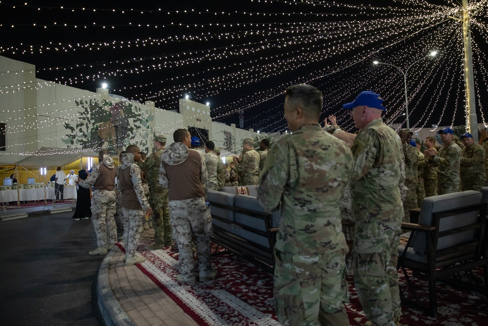 West Virginia, District of Columbia National Guard Members, and Qatar National Service Academy cadets enjoy traditional Qatari food prepared and served by staff at the National Service Academy