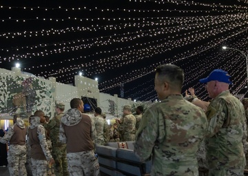 West Virginia, District of Columbia National Guard Members, and Qatar National Service Academy cadets enjoy traditional Qatari food prepared and served by staff at the National Service Academy