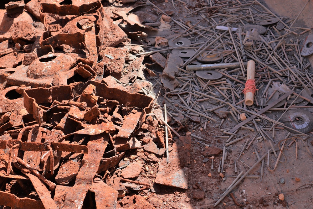 Corroding Metal Unearthed During Military Construction is Gathered for Recycling