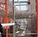 Construction Workers Maintain a Tidy Worksite Between Scaffolding of a Building Under Construction on Marine Corps Base Camp Blaz