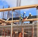 Construction Workers Work on the Envelope of a Building Under Construction