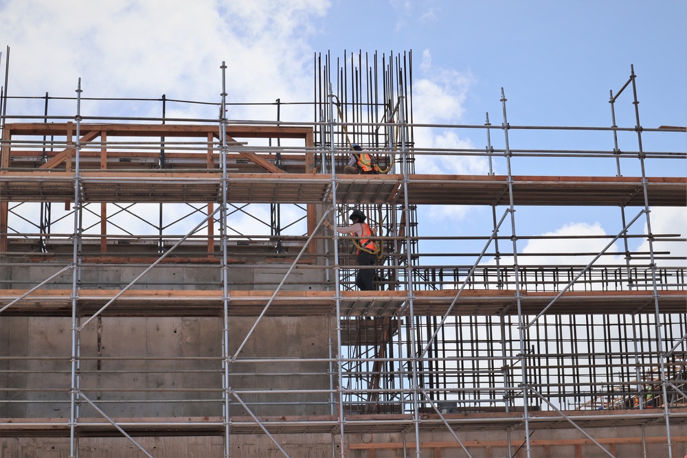 Contractors Work on the Exterior of  a Building Under Construction on Marine Corps Base Camp Blaz