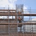 Contractors Work on the Exterior of  a Building Under Construction on Marine Corps Base Camp Blaz